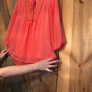 Tangerine colored two piece blouse.